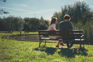 Couple sitting on park bench