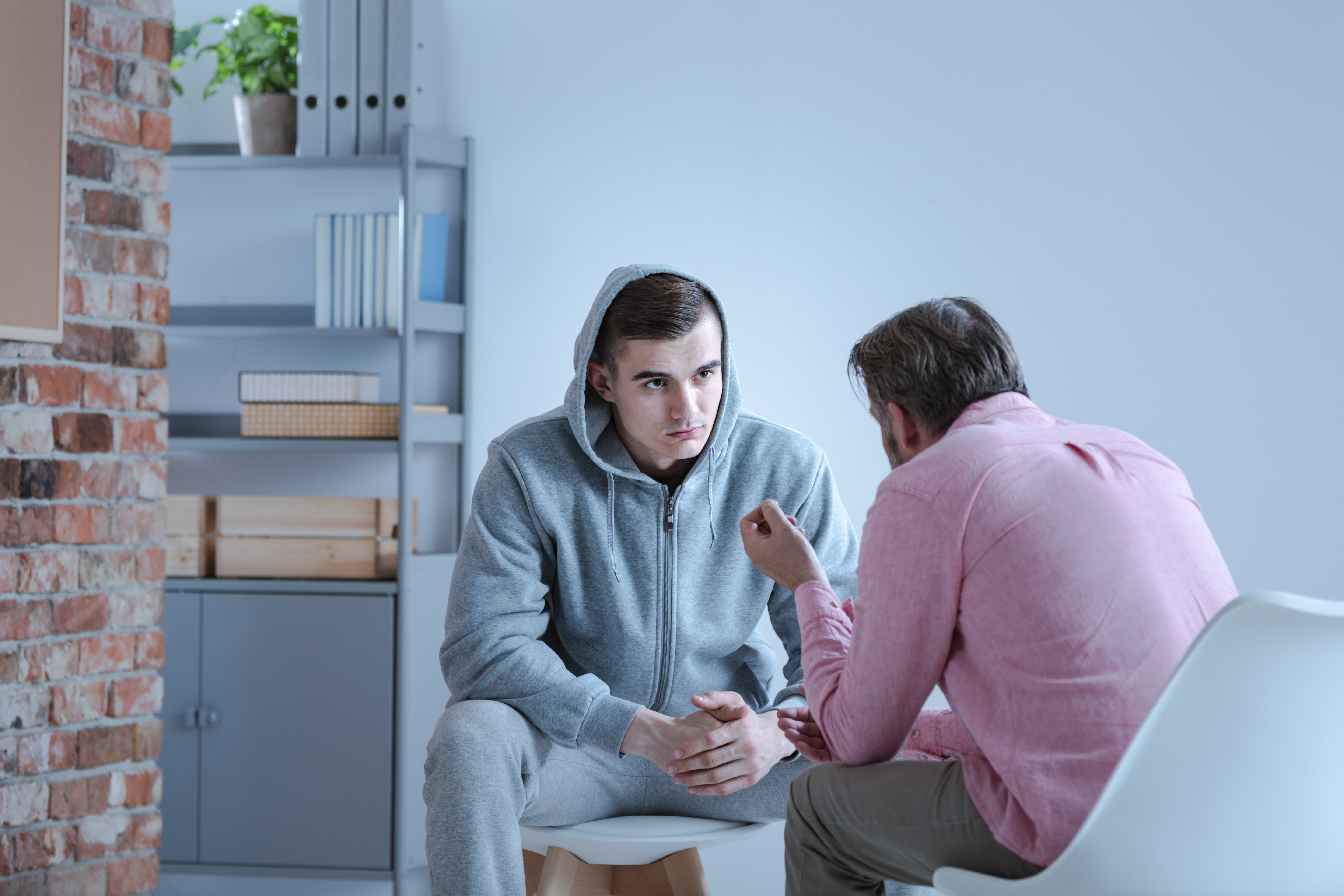 Man talks contemplatively with therapist or mentor